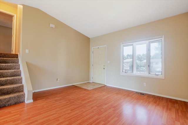 6 Starlight Ct, Bloomington, IL 61704 - spare room featuring light wood finished floors, stairway, and lofted ceiling