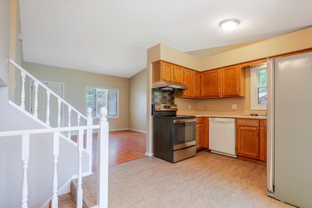 6 Starlight Ct, Bloomington, IL 61704 - kitchen with white appliances, under cabinet range hood, light colored carpet, light countertops, and brown cabinetry