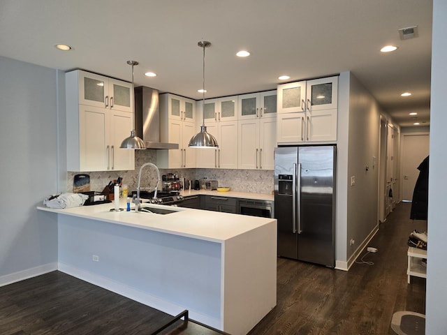 2744 N Lincoln Ave Unit 2, Chicago, IL 60614 - kitchen with appliances with stainless steel finishes, wall chimney range hood, a peninsula, dark wood-style flooring, and recessed lighting
