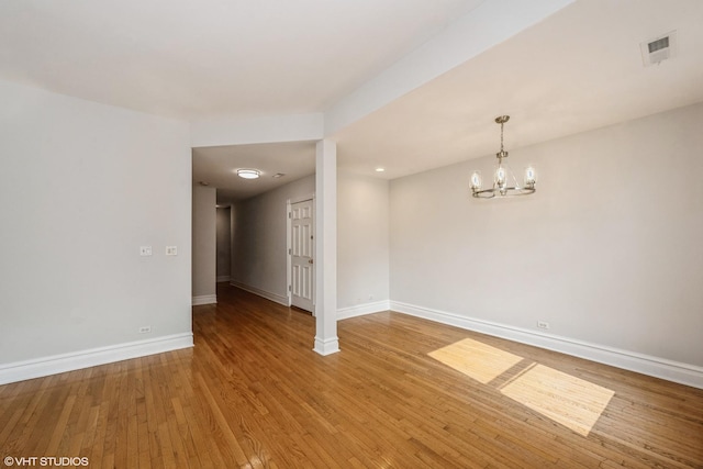 3252 S Prairie Ave Unit 2S, Chicago, IL 60616 - empty room featuring a chandelier and wood finished floors