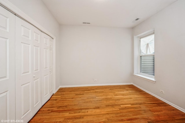 3252 S Prairie Ave Unit 2S, Chicago, IL 60616 - unfurnished bedroom with light wood-type flooring and a closet
