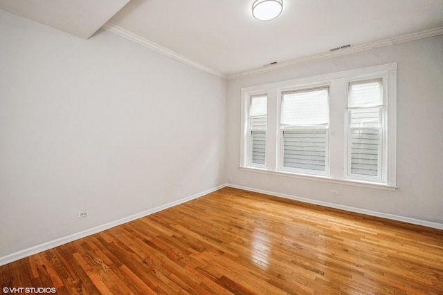 3252 S Prairie Ave Unit 2S, Chicago, IL 60616 - spare room with light wood-style flooring and ornamental molding