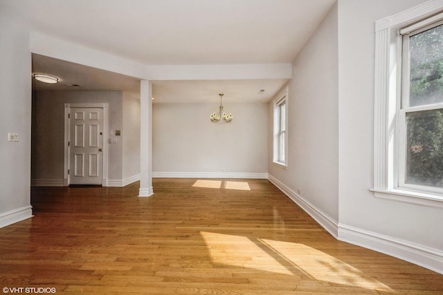 3252 S Prairie Ave Unit 2S, Chicago, IL 60616 - spare room featuring a chandelier and wood finished floors