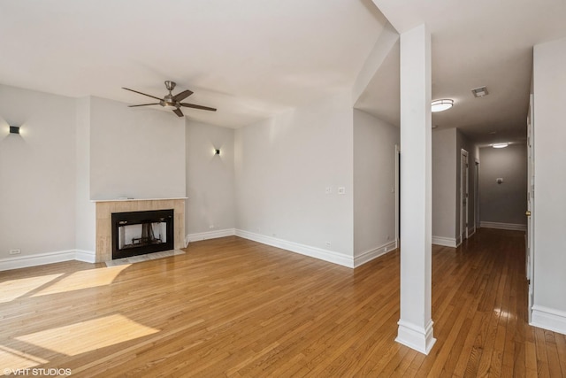 3252 S Prairie Ave Unit 2S, Chicago, IL 60616 - unfurnished living room with ceiling fan, wood-type flooring, and a tiled fireplace