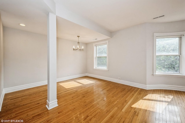 3252 S Prairie Ave Unit 2S, Chicago, IL 60616 - empty room featuring healthy amount of natural light, hardwood / wood-style floors, and a chandelier