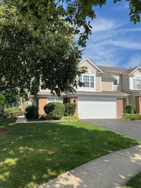 372 S Crown Ct, Palatine, IL 60074 - view of front facade featuring brick siding, asphalt driveway, a front lawn, and an attached garage