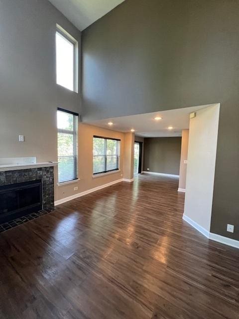 372 S Crown Ct, Palatine, IL 60074 - unfurnished living room featuring a fireplace with flush hearth, high vaulted ceiling, and dark wood-type flooring