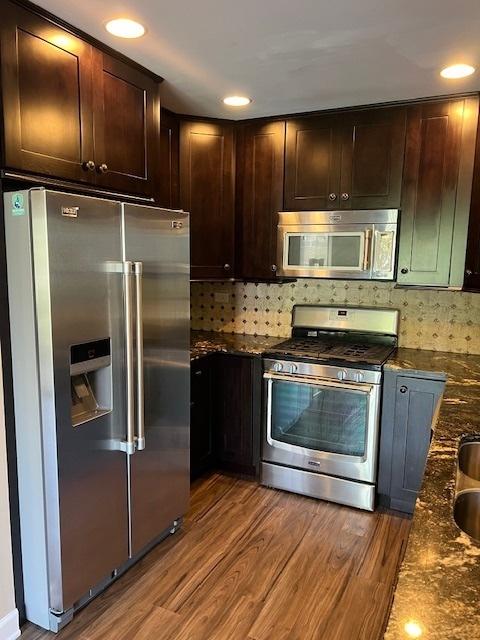 372 S Crown Ct, Palatine, IL 60074 - kitchen with appliances with stainless steel finishes, wood finished floors, dark brown cabinets, decorative backsplash, and recessed lighting
