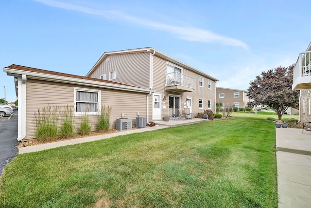 7926 164th Pl Unit 7926, Tinley Park, IL 60477 - rear view of house featuring a balcony, a yard, and a patio
