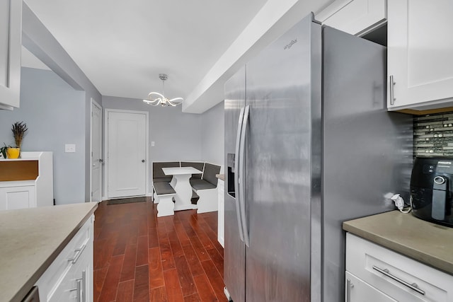 7926 164th Pl Unit 7926, Tinley Park, IL 60477 - kitchen featuring stainless steel fridge, a chandelier, dark wood finished floors, white cabinets, and decorative backsplash