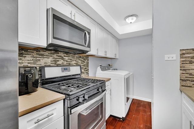 7926 164th Pl Unit 7926, Tinley Park, IL 60477 - kitchen featuring stainless steel appliances, washing machine and dryer, tasteful backsplash, dark wood-style floors, and white cabinets