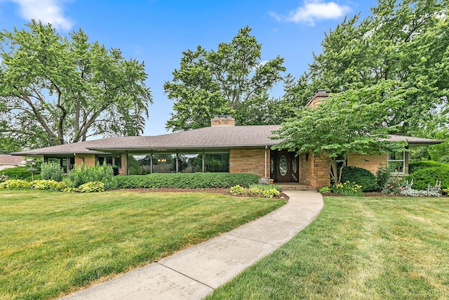 306 Wing Park Blvd, Elgin, IL 60123 - view of front of property featuring a front lawn, a chimney, and stone siding