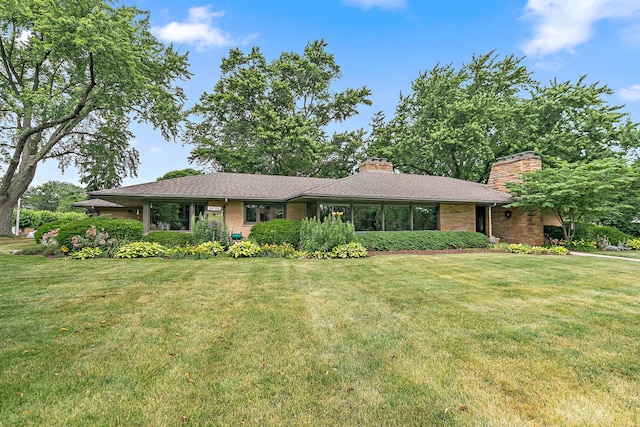 306 Wing Park Blvd, Elgin, IL 60123 - view of front of home featuring a chimney and a front yard