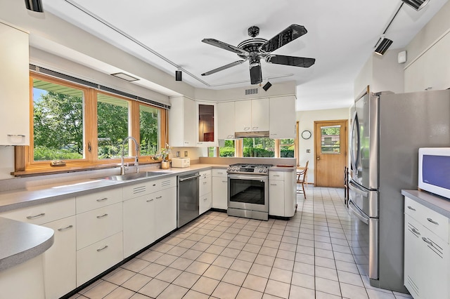 306 Wing Park Blvd, Elgin, IL 60123 - kitchen featuring appliances with stainless steel finishes, a ceiling fan, white cabinetry, light countertops, and light tile patterned flooring
