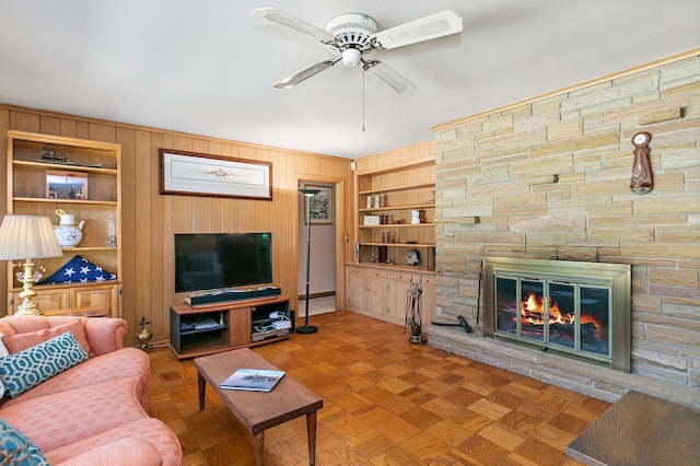 306 Wing Park Blvd, Elgin, IL 60123 - living area featuring a ceiling fan, built in shelves, wood walls, and a stone fireplace
