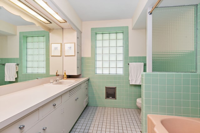 306 Wing Park Blvd, Elgin, IL 60123 - bathroom with tile walls, vanity, a bath, tile patterned flooring, and a wainscoted wall