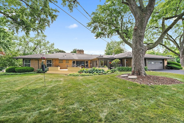 306 Wing Park Blvd, Elgin, IL 60123 - view of green lawn featuring driveway, a wooden deck, and a sunroom