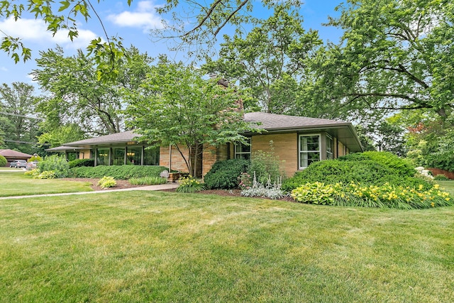306 Wing Park Blvd, Elgin, IL 60123 - view of front facade with a front lawn, brick siding, and roof with shingles