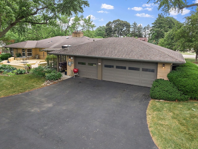 306 Wing Park Blvd, Elgin, IL 60123 - ranch-style house with a chimney, driveway, a garage, a front lawn, and a shingled roof