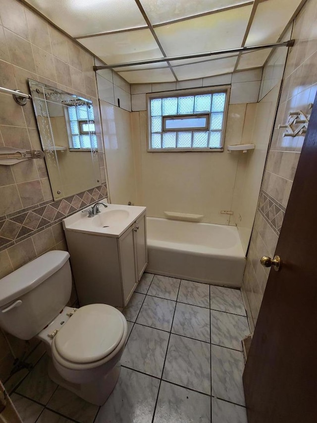 15408 Dobson Ave, Dolton, IL 60419 - full bathroom featuring shower / washtub combination, healthy amount of natural light, vanity, tile walls, and marble finish floors