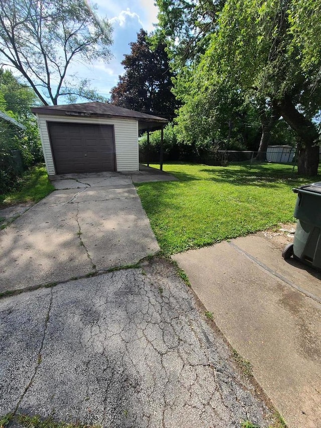 15408 Dobson Ave, Dolton, IL 60419 - view of yard featuring an outdoor structure, driveway, and a detached garage