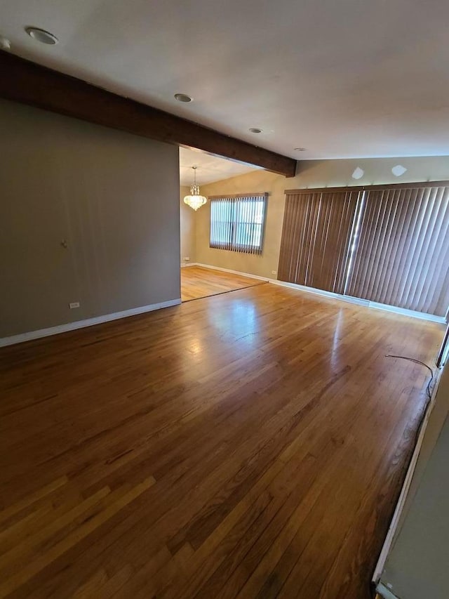15408 Dobson Ave, Dolton, IL 60419 - spare room featuring beam ceiling, wood finished floors, and a chandelier