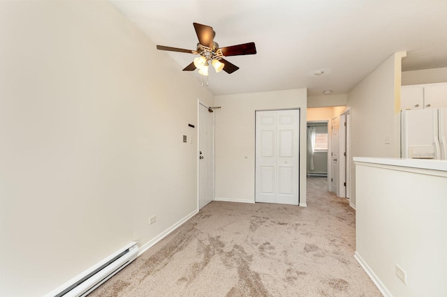 1131 Cedar St Unit 2B, Glendale Heights, IL 60139 - unfurnished bedroom featuring freestanding refrigerator, baseboard heating, light carpet, ceiling fan, and a closet