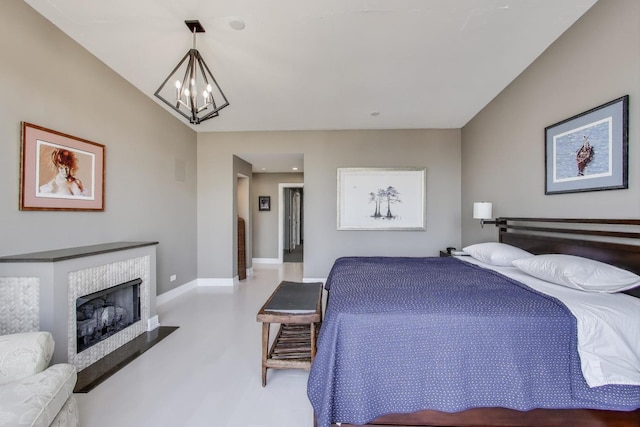 1001 W Madison St Unit 710, Chicago, IL 60607 - bedroom featuring a chandelier, a fireplace with flush hearth, and recessed lighting
