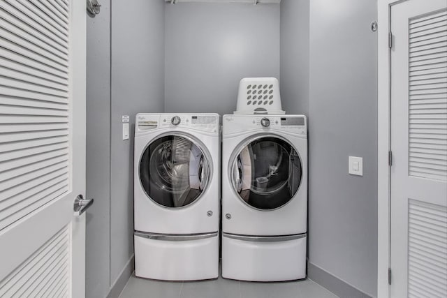 1001 W Madison St Unit 710, Chicago, IL 60607 - washroom featuring separate washer and dryer and tile patterned flooring