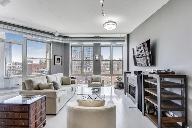 1001 W Madison St Unit 710, Chicago, IL 60607 - living area featuring a view of city, floor to ceiling windows, plenty of natural light, and a fireplace