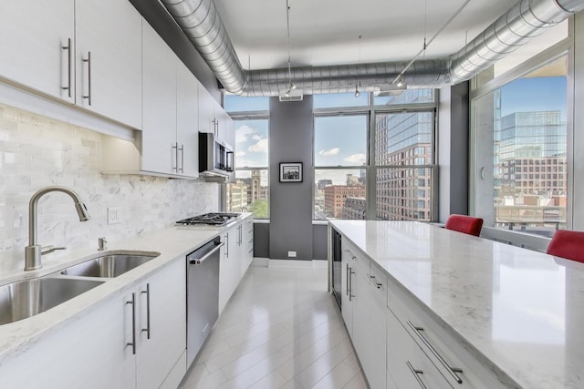 1001 W Madison St Unit 710, Chicago, IL 60607 - kitchen featuring stainless steel appliances, decorative backsplash, plenty of natural light, and a city view