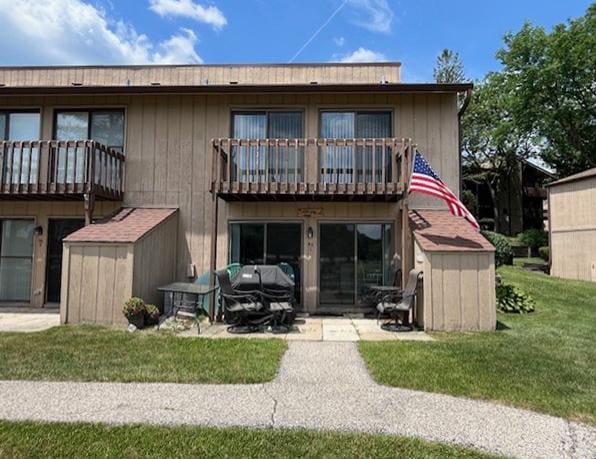 56 Vail Colony Unit 1, Fox Lake, IL 60020 - back of house with a balcony, a shed, and a yard