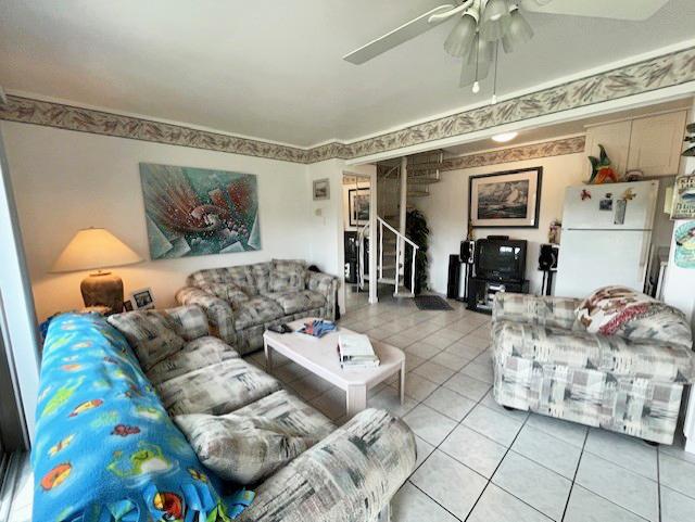 56 Vail Colony Unit 1, Fox Lake, IL 60020 - living area featuring light tile patterned floors, stairway, and ceiling fan