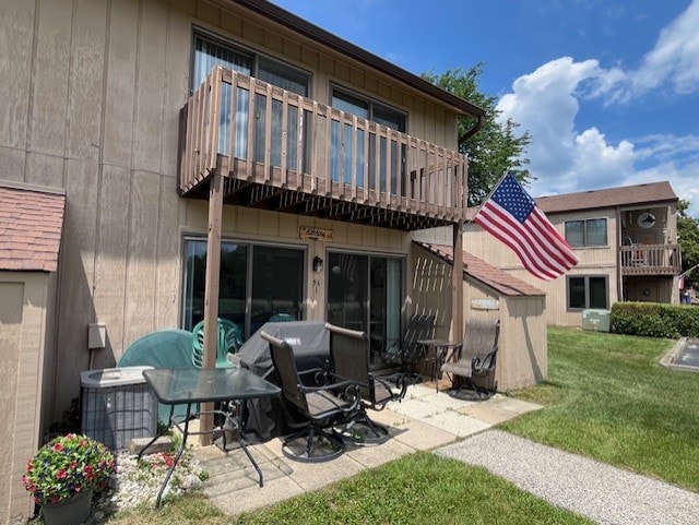 56 Vail Colony Unit 1, Fox Lake, IL 60020 - back of property with a balcony, a yard, and a patio area