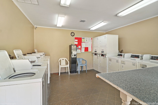 56 Vail Colony Unit 1, Fox Lake, IL 60020 - shared laundry featuring stacked washing machine and dryer, separate washer and dryer, ornamental molding, and dark flooring