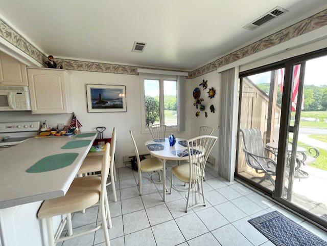 56 Vail Colony Unit 1, Fox Lake, IL 60020 - dining area featuring light tile patterned floors