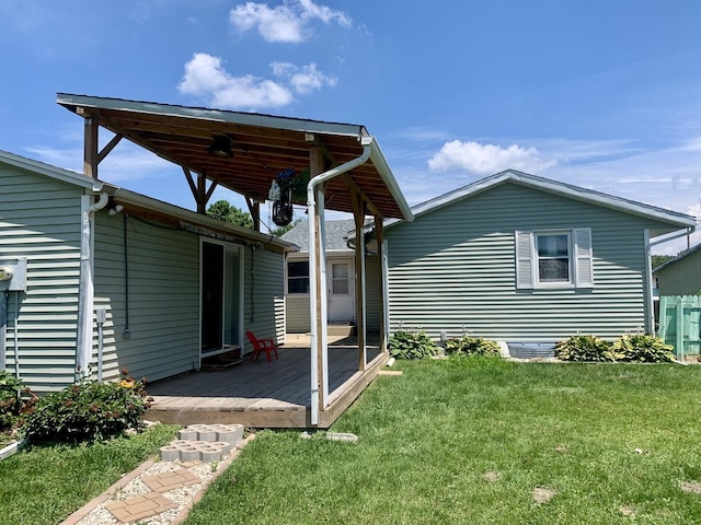 3122 Arlington Dr, Princeton, IL 61356 - rear view of house with a deck and a lawn