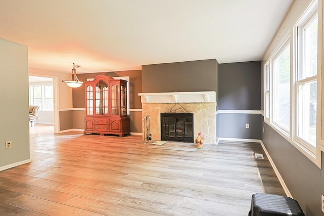 108 Poplar St, Mchenry, IL 60051 - unfurnished living room featuring plenty of natural light, wood finished floors, and a stone fireplace