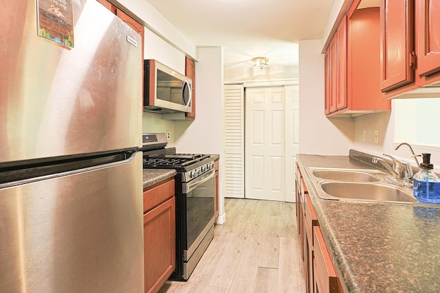 108 Poplar St, Mchenry, IL 60051 - kitchen with appliances with stainless steel finishes, dark countertops, and light wood-style flooring