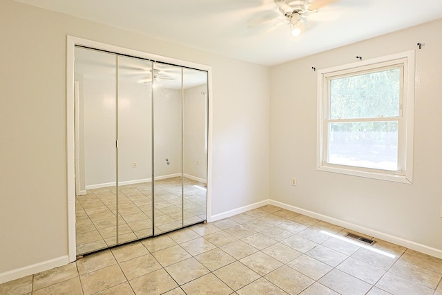108 Poplar St, Mchenry, IL 60051 - unfurnished bedroom with light tile patterned flooring, a closet, and ceiling fan