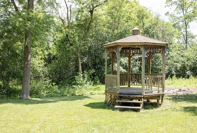 108 Poplar St, Mchenry, IL 60051 - view of green lawn with a gazebo, a wooden deck, and view of wooded area