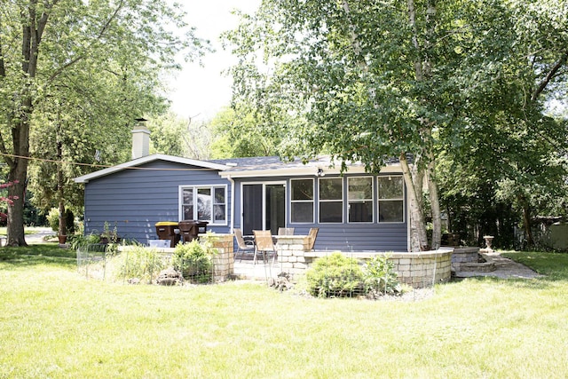 108 Poplar St, Mchenry, IL 60051 - back of property featuring a chimney, a yard, and a patio area