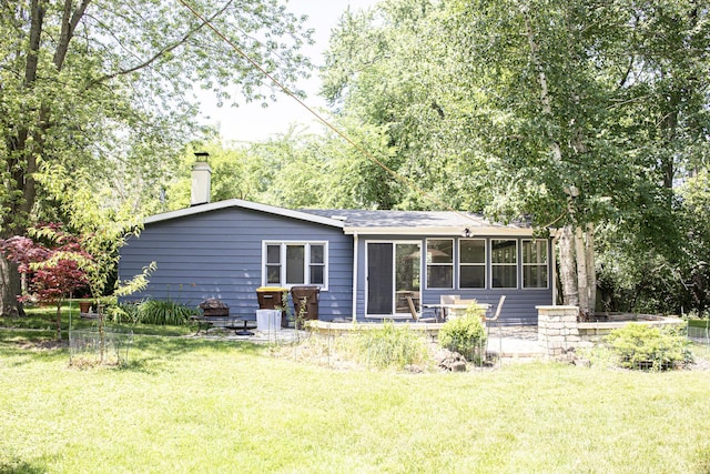 108 Poplar St, Mchenry, IL 60051 - back of property featuring a yard, a sunroom, and a chimney