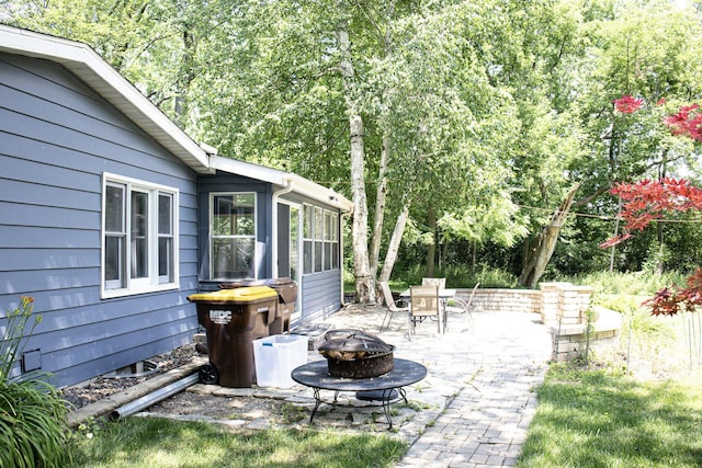 108 Poplar St, Mchenry, IL 60051 - view of patio featuring an outdoor fire pit and a sunroom