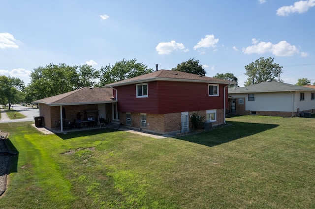 17513 Cypress Ave, Country Club Hills, IL 60478 - rear view of house featuring a yard, brick siding, and a patio area