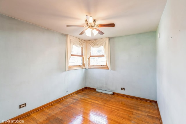 13247 S S Ave M, Chicago, IL 60633 - spare room featuring a ceiling fan, hardwood / wood-style flooring, and a baseboard radiator