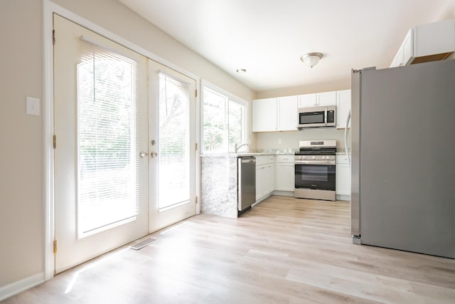 447 Yorkshire Sq, Bolingbrook, IL 60440 - kitchen with stainless steel appliances, white cabinets, light wood-type flooring, french doors, and light countertops