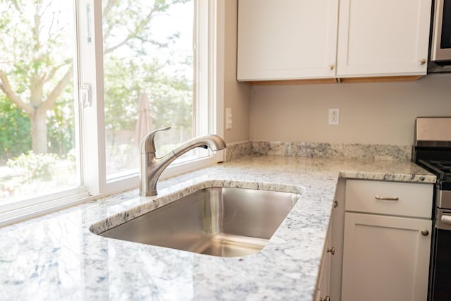 447 Yorkshire Sq, Bolingbrook, IL 60440 - kitchen with stainless steel appliances, white cabinetry, and light stone counters