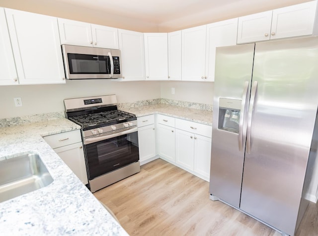 447 Yorkshire Sq, Bolingbrook, IL 60440 - kitchen featuring stainless steel appliances, light wood-style floors, white cabinets, and light stone countertops