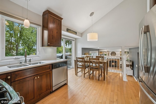 930 Bristol Trail Rd, Lake Zurich, IL 60047 - kitchen featuring appliances with stainless steel finishes, decorative light fixtures, light wood finished floors, light countertops, and tasteful backsplash